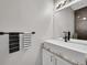 Modern powder room features a sleek sink, dark fixtures, and sophisticated design at 10571 Garfield St, Thornton, CO 80233