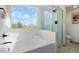 Primary bath with soaking tub and glass-enclosed shower provide a spa-like experience at 10703 Jordan Ct, Parker, CO 80134