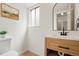 Updated bathroom features modern vanity, wood-look flooring, and decorative art at 10703 Jordan Ct, Parker, CO 80134