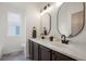 Bathroom features double sinks, stone countertops, and modern fixtures, providing a spa-like experience at 10703 Jordan Ct, Parker, CO 80134