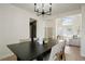 Dining room with modern chandelier and view into the light-filled living room at 10703 Jordan Ct, Parker, CO 80134