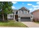 Charming two-story home featuring a gray exterior, manicured lawn, and attached two-car garage at 10703 Jordan Ct, Parker, CO 80134