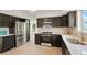 Modern kitchen features stainless steel appliances, dark cabinetry, and light countertops at 10703 Jordan Ct, Parker, CO 80134