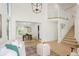 Open-concept living room with high ceilings, dining area, and staircase to loft, offering bright and airy space at 10703 Jordan Ct, Parker, CO 80134
