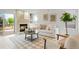 Inviting living room with cozy fireplace, natural light, and access to the backyard deck at 10703 Jordan Ct, Parker, CO 80134