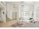 Bright living room with large windows, vaulted ceiling, light hardwood floors, and neutral furniture at 10703 Jordan Ct, Parker, CO 80134