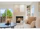 Cozy living room with a brick fireplace, backyard views, and neutral decor at 10703 Jordan Ct, Parker, CO 80134