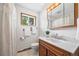 Bathroom showcasing a vanity, window, and shower with curtain at 6327 Fenton St, Arvada, CO 80003