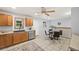 This kitchen features a stainless steel dishwasher, brown cabinets, and a ceiling fan at 6327 Fenton St, Arvada, CO 80003