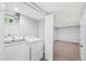 Laundry room with washer and dryer and connecting to an unfinished basement at 6327 Fenton St, Arvada, CO 80003