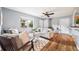 Comfortable living room featuring neutral tones, hardwood floors, and large windows at 6327 Fenton St, Arvada, CO 80003
