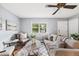 Bright and inviting living room with stylish furniture, hardwood floors, and natural light at 6327 Fenton St, Arvada, CO 80003