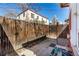 Backyard with brick patio, privacy fence, and a glimpse of the surrounding neighborhood at 2023 E 20Th Ave, Denver, CO 80205