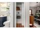 Bright bathroom featuring stylish fixtures, floating shelves, and modern vanity with ample storage at 2023 E 20Th Ave, Denver, CO 80205