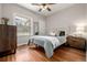 Cozy bedroom with hardwood floors, a ceiling fan, and a large window for natural light at 2023 E 20Th Ave, Denver, CO 80205