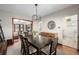 Open dining room featuring wood floors, an elegant chandelier, and views into the living room and kitchen at 2023 E 20Th Ave, Denver, CO 80205