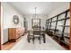 Formal dining room with hardwood floors, large table, modern light fixture, and stylish shelving at 2023 E 20Th Ave, Denver, CO 80205