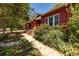 Landscaped front yard and pathway leading to the charming red brick home at 2023 E 20Th Ave, Denver, CO 80205
