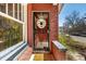 Welcoming front door with decorative wreath, window and brick facade at 2023 E 20Th Ave, Denver, CO 80205