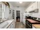 Bright kitchen featuring white cabinets, stainless steel appliances, and a stylish tile backsplash at 2023 E 20Th Ave, Denver, CO 80205