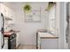 Bright kitchen featuring white cabinets, stainless steel appliances, and butcher block countertops at 2023 E 20Th Ave, Denver, CO 80205