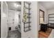 Efficient laundry room featuring modern stacked washer and dryer set, shelving, and a side entry door at 2023 E 20Th Ave, Denver, CO 80205