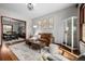 Comfortable living room featuring hardwood floors, a modern light fixture, and stylish furnishings at 2023 E 20Th Ave, Denver, CO 80205