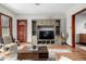 Cozy living room showcasing a stylish entertainment center, hardwood floors, and a warm, inviting atmosphere at 2023 E 20Th Ave, Denver, CO 80205