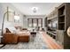 Bright and airy living room featuring a comfortable sofa, hardwood floors, and a modern entertainment unit at 2023 E 20Th Ave, Denver, CO 80205