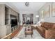 Inviting living room featuring a large entertainment center and hardwood floors and connection to the dining room at 2023 E 20Th Ave, Denver, CO 80205