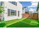 Home featuring artificial grass, privacy fence, and a modern exterior at 3632 Lipan St, Denver, CO 80211