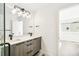 Modern bathroom featuring double sinks with stylish faucets and a contemporary light fixture at 3632 Lipan St, Denver, CO 80211