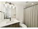 Modern bathroom featuring a single sink with stylish faucet and a shower with patterned curtain at 3632 Lipan St, Denver, CO 80211