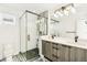 Modern bathroom featuring double vanity, sleek fixtures, and glass-enclosed shower at 3632 Lipan St, Denver, CO 80211