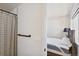 Modern bathroom featuring a shower with patterned curtain across from an adjoining bedroom at 3632 Lipan St, Denver, CO 80211