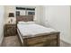 Bedroom with a wooden bed frame, side table, and window providing natural light at 3632 Lipan St, Denver, CO 80211