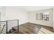 Bonus room with hardwood floors, railing and a window providing natural light at 3632 Lipan St, Denver, CO 80211