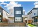 Contemporary two-story home with a modern blue and gray design, framed by adjacent houses and a wooden fence at 3632 Lipan St, Denver, CO 80211