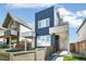 Modern two-story home with a striking blue and gray exterior, complemented by a stylish wooden fence at 3632 Lipan St, Denver, CO 80211