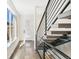 Bright foyer showcasing a modern staircase and hardwood floors, complemented by a large window at 3632 Lipan St, Denver, CO 80211