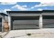 Gray two car detached garage with blue skies and minimal landscaping in the background at 3632 Lipan St, Denver, CO 80211