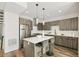 Modern kitchen featuring stainless steel appliances, stylish cabinetry, and a functional island with seating at 3632 Lipan St, Denver, CO 80211