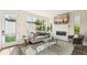 Cozy living room with a fireplace, plush sofa, and ample natural light flooding through the large window at 3632 Lipan St, Denver, CO 80211