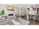 Open-concept living room with a fireplace, modern decor, and seamless flow into the kitchen and dining area at 3632 Lipan St, Denver, CO 80211