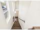 Bright and airy stairwell with hardwood steps, modern railings, and large windows at 3632 Lipan St, Denver, CO 80211