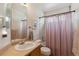 Cozy bathroom with tub/shower, large mirror, and neutral colors at 10517 Madison St, Thornton, CO 80233