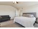 Bright primary bedroom with vaulted ceiling, gray loveseat, and neutral-colored walls at 10517 Madison St, Thornton, CO 80233