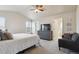 Bright primary bedroom features vaulted ceiling, gray dresser with TV, and neutral-colored walls at 10517 Madison St, Thornton, CO 80233