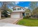 Charming two-story home featuring a two car garage, mature landscaping, and a beautiful lawn at 10517 Madison St, Thornton, CO 80233