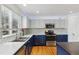 Modern kitchen with quartz counters, stainless appliances, hardwood floors, and a large window at 10517 Madison St, Thornton, CO 80233